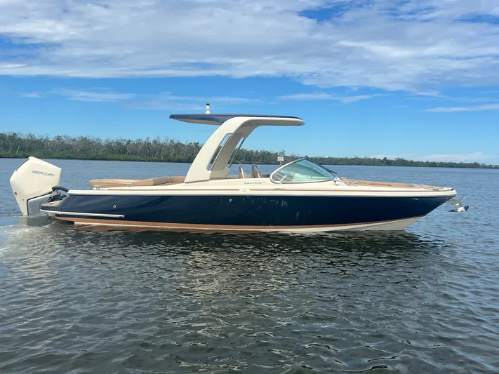  Yacht Photos Pics 2024 Chris-Craft Launch 25 GT boat on calm water under a blue sky.