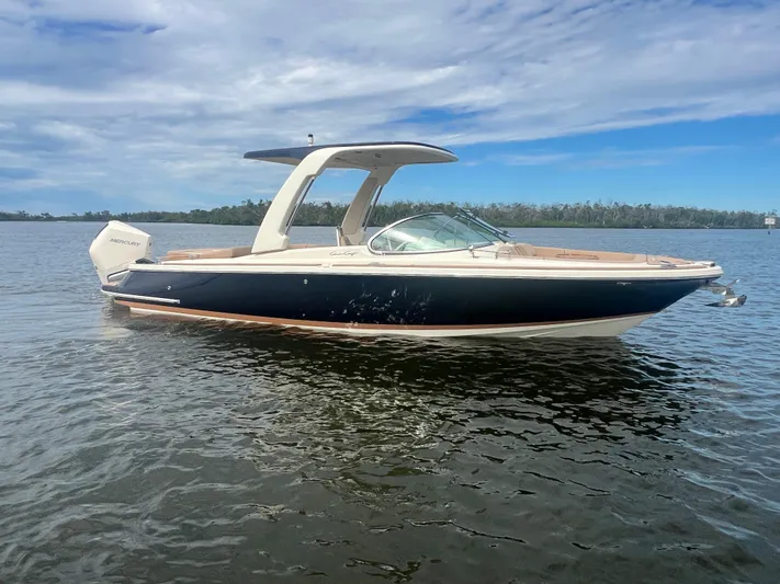  Yacht Photos Pics 2024 Chris-Craft Launch 25 GT boat on calm water under a partly cloudy sky.