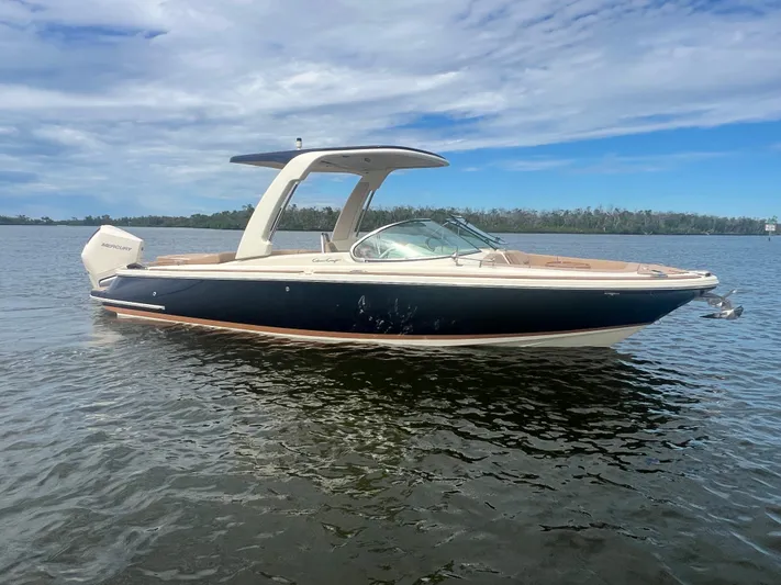  Yacht Photos Pics 2024 Chris-Craft Launch 25 GT boat on calm water under a blue sky.
