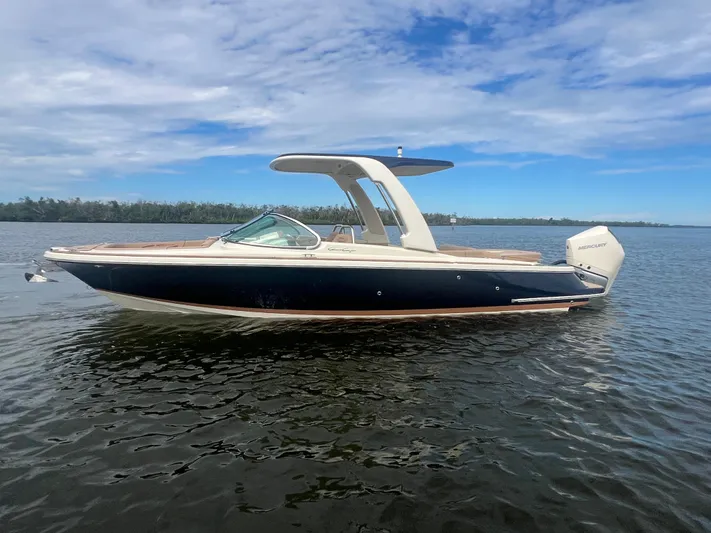  Yacht Photos Pics 2024 Chris-Craft Launch 25 GT boat on calm water under a blue sky.