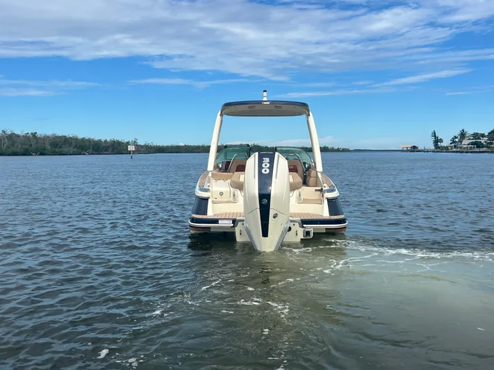  Yacht Photos Pics 2024 Chris-Craft Launch 25 GT boat on calm water, rear view.