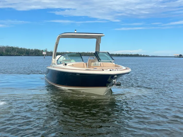  Yacht Photos Pics 2024 Chris-Craft Launch 25 GT boat on calm water under a clear blue sky.