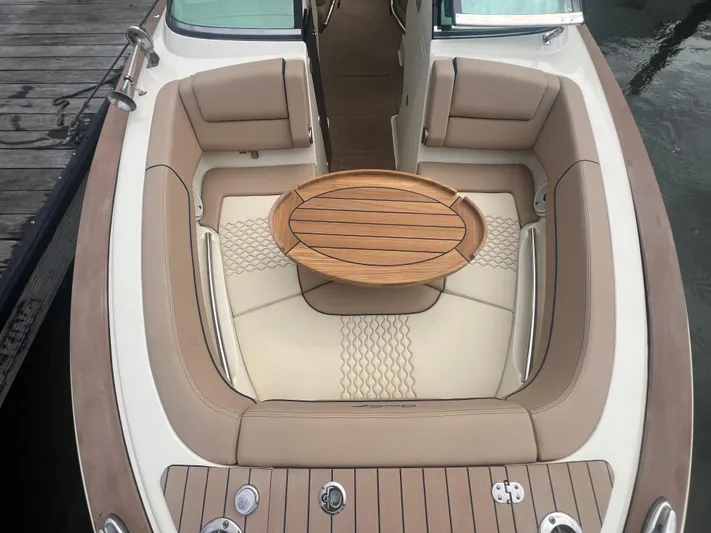  Yacht Photos Pics 2024 Chris-Craft Launch 25 GT boat interior with elegant seating and wooden table.