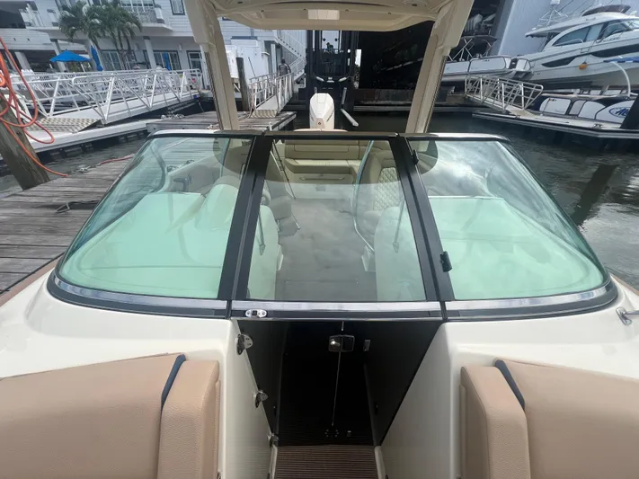  Yacht Photos Pics 2024 Chris-Craft Launch 25 GT boat interior with windshield, docked at marina.