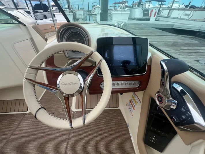  Yacht Photos Pics 2024 Chris-Craft Launch 25 GT dashboard with steering wheel and touchscreen display.