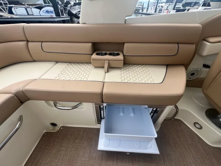  Yacht Photos Pics 2024 Chris-Craft Launch 25 GT interior with tan seating and storage drawer open.