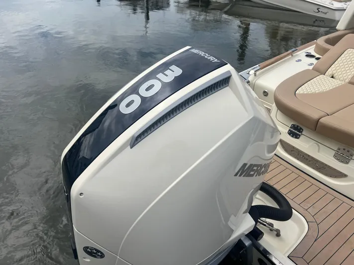  Yacht Photos Pics 2024 Chris-Craft Launch 25 GT with Mercury 300 outboard engine, docked on calm water.