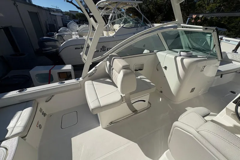  Yacht Photos Pics 2025 World Cat 230 DC boat interior with white seating and modern design.