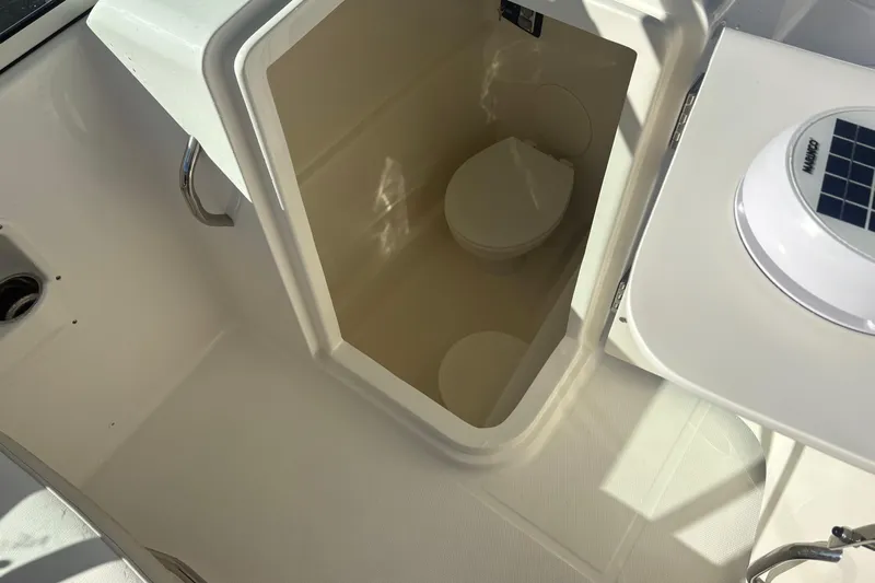  Yacht Photos Pics 2025 World Cat 230 DC boat interior with compact marine toilet.
