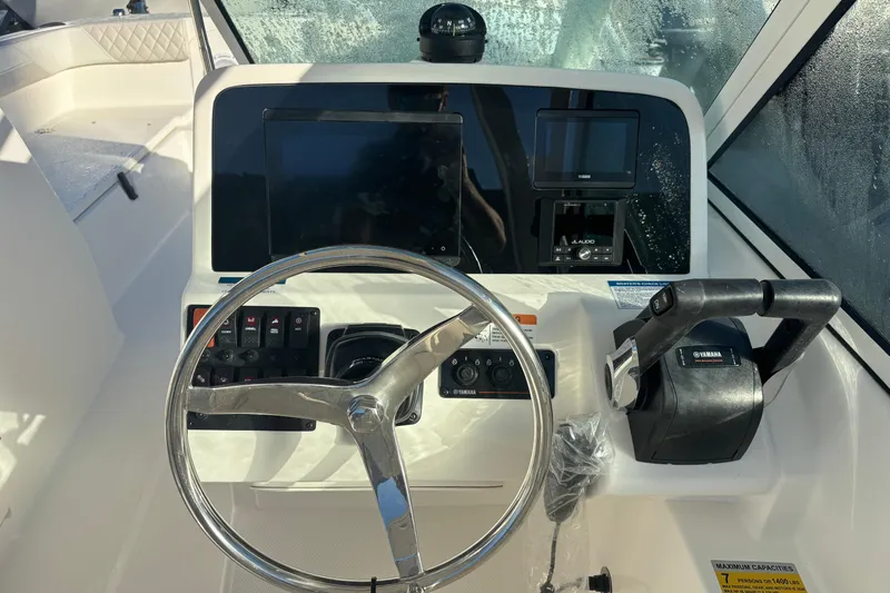  Yacht Photos Pics 2025 World Cat 230 DC boat dashboard with steering wheel and Yamaha controls.