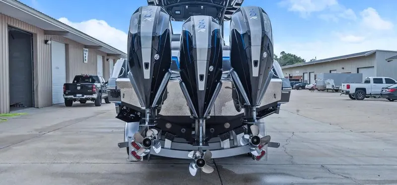  Yacht Photos Pics 2023 Nor-Tech 390 Sport Center Console with quad engines, parked in an industrial area.