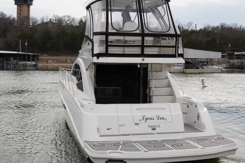  Yacht Photos Pics 2009 Sea Ray 47 Sedan Bridge yacht on water, rear view, named "Lyons Den."