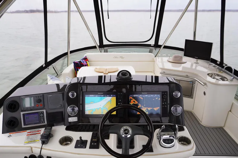  Yacht Photos Pics 2009 Sea Ray 47 Sedan Bridge helm with navigation screens and luxurious seating.