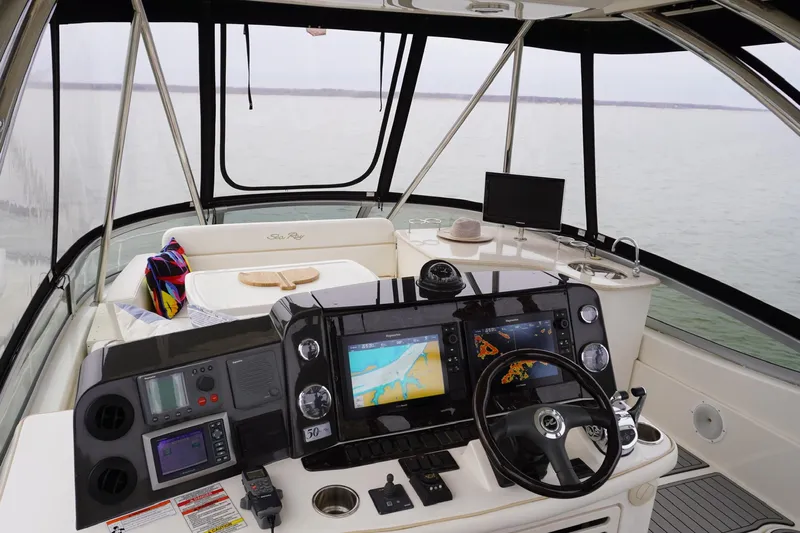  Yacht Photos Pics 2009 Sea Ray 47 Sedan Bridge helm with navigation screens and panoramic water view.