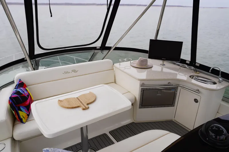  Yacht Photos Pics Luxurious interior of 2009 Sea Ray 47 Sedan Bridge yacht with seating and kitchenette.