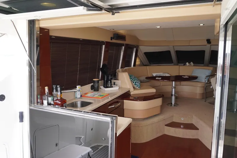  Yacht Photos Pics Luxurious interior of 2009 Sea Ray 47 Sedan Bridge yacht with kitchen and seating area.