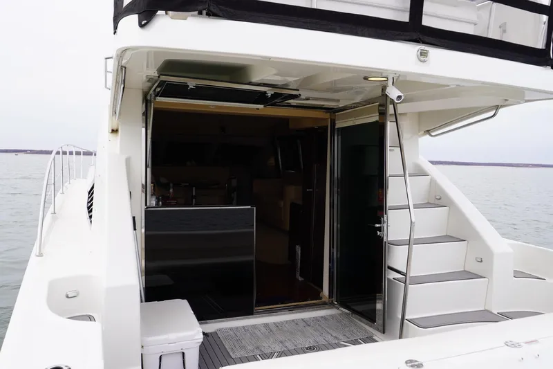  Yacht Photos Pics 2009 Sea Ray 47 Sedan Bridge yacht with open cabin door and exterior stairs.