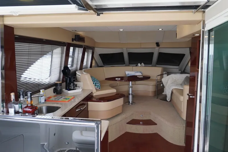  Yacht Photos Pics Luxurious interior of 2009 Sea Ray 47 Sedan Bridge yacht with elegant seating and kitchenette.