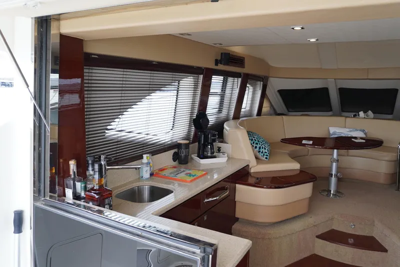  Yacht Photos Pics Luxurious interior of 2009 Sea Ray 47 Sedan Bridge yacht with kitchen and seating area.