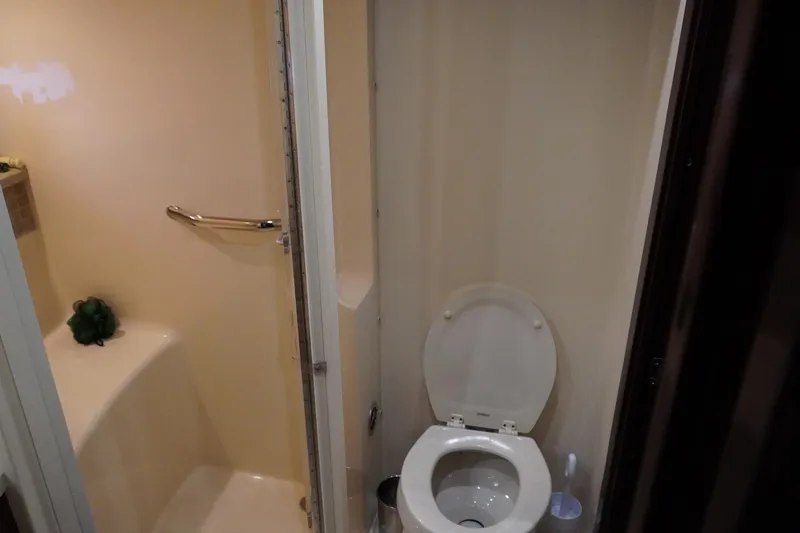  Yacht Photos Pics Bathroom interior of 2009 Sea Ray 47 Sedan Bridge yacht, featuring toilet and shower area.