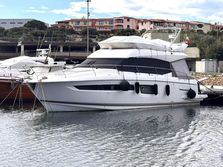 Pure Yacht Photos Pics 2016 Prestige 500 yacht docked in a marina with scenic background.