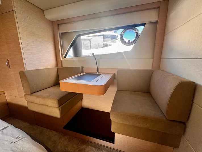 Pure Yacht Photos Pics Interior of 2016 Prestige 500 yacht with cozy seating and window view.