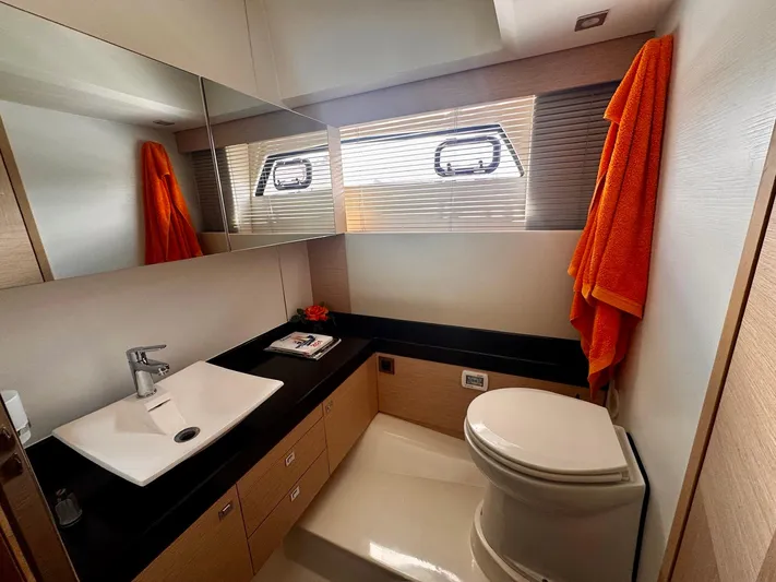 Pure Yacht Photos Pics Luxurious bathroom in 2016 Prestige 500 yacht with modern fixtures and orange towel accents.