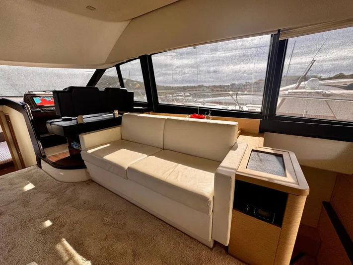 Pure Yacht Photos Pics Luxurious interior of a 2016 Prestige 500 yacht with beige sofa and panoramic windows.