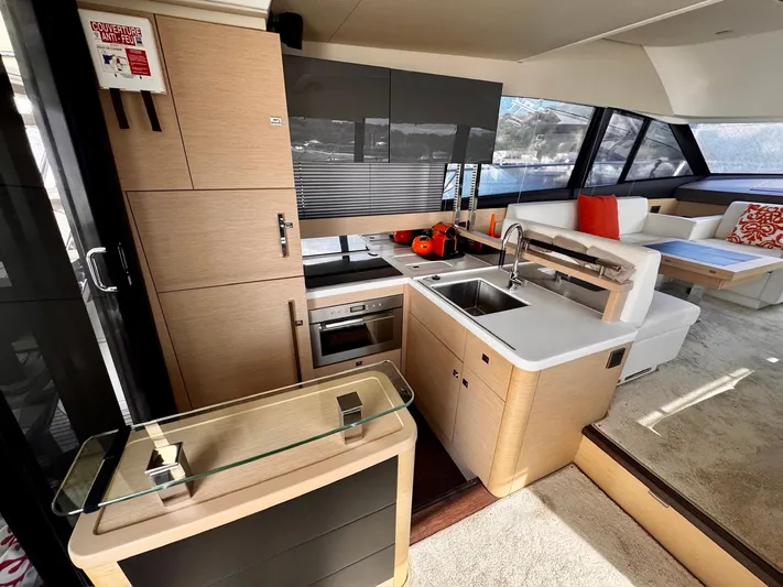 Pure Yacht Photos Pics Luxurious interior of a 2016 Prestige 500 yacht featuring a modern kitchen and seating area.