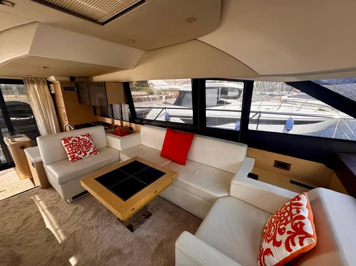 Pure Yacht Photos Pics Luxurious interior of a 2016 Prestige 500 yacht with white seating and red accents.