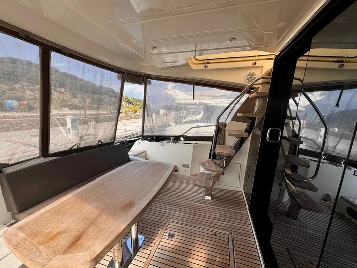 Pure Yacht Photos Pics Interior of 2016 Prestige 500 yacht with wooden flooring and seating area.