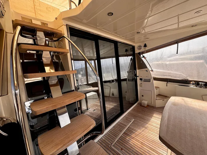 Pure Yacht Photos Pics Interior of 2016 Prestige 500 yacht with wooden stairs and sleek design.