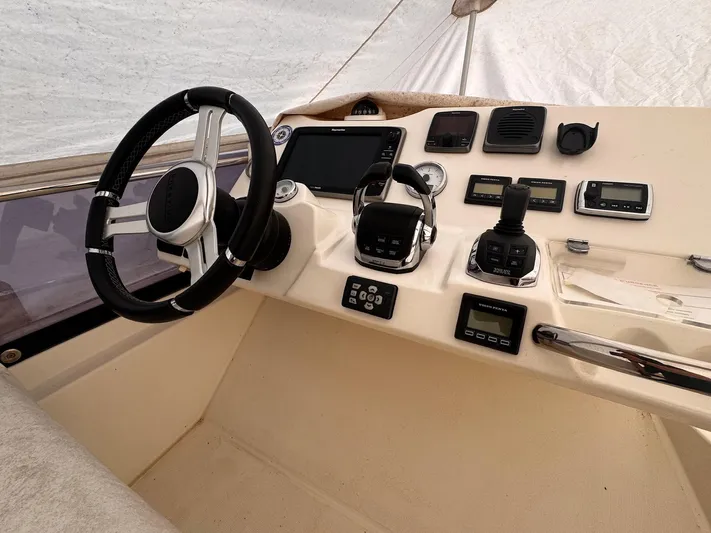 Pure Yacht Photos Pics Helm of 2016 Prestige 500 yacht with steering wheel and navigation controls.