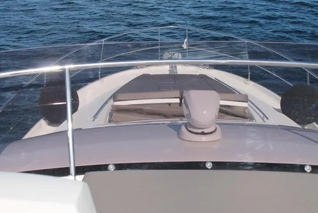Pure Yacht Photos Pics 2016 Prestige 500 yacht bow with sunbathing area on calm ocean waters.