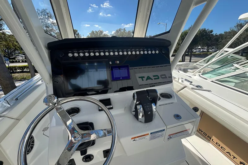  Yacht Photos Pics 2026 World Cat 265 CC-X boat dashboard with steering wheel and control panel.