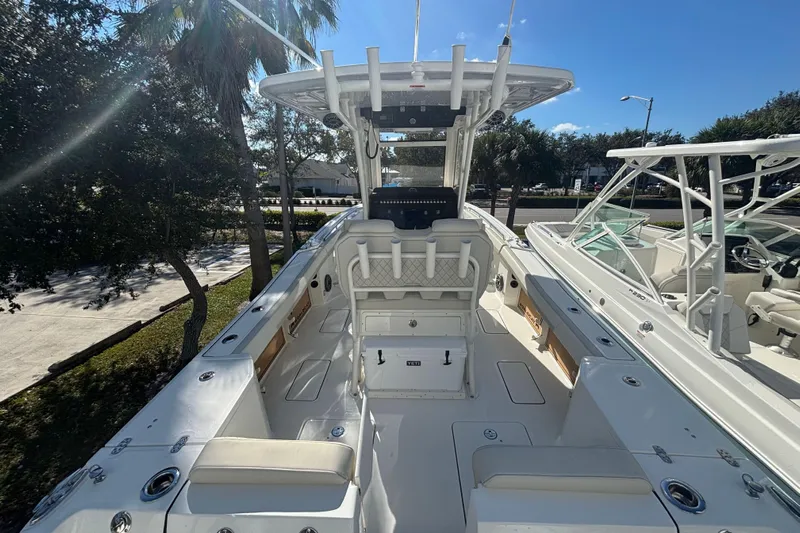  Yacht Photos Pics 2026 World Cat 265 CC-X boat interior with seating and console, under clear blue sky.