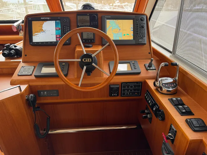 Hezitation Yacht Photos Pics 2009 Grand Banks 45 Eastbay SX helm with navigation screens and wooden steering wheel.
