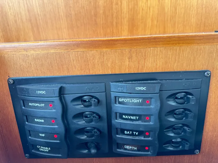 Hezitation Yacht Photos Pics Control panel on 2009 Grand Banks 45 Eastbay SX with labeled switches for navigation and communication.