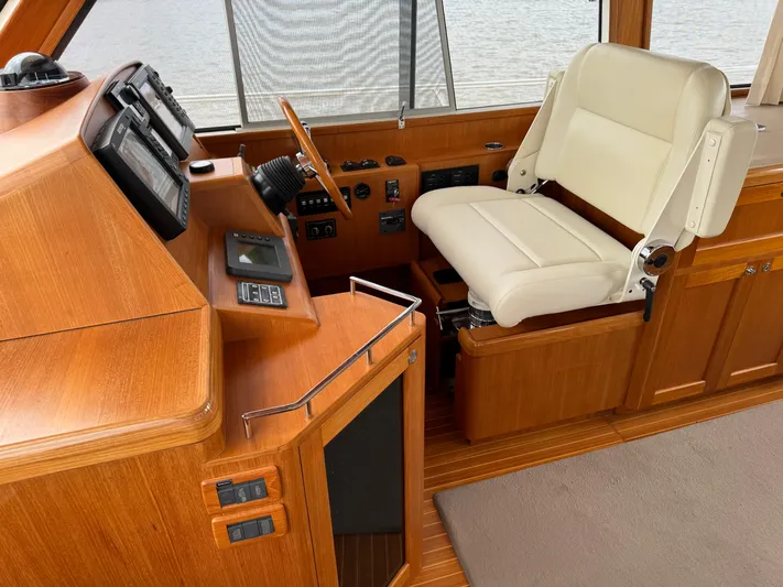 Hezitation Yacht Photos Pics 2009 Grand Banks 45 Eastbay SX helm with wooden dashboard and white captain's chair.