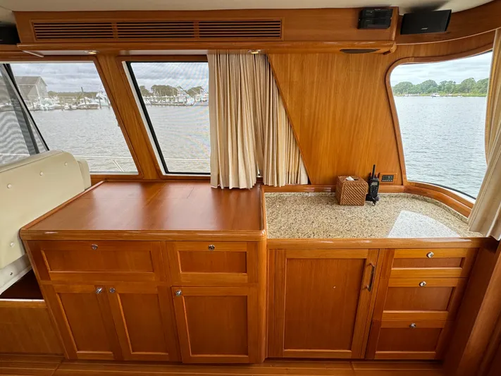 Hezitation Yacht Photos Pics 2009 Grand Banks 45 Eastbay SX interior with wooden cabinetry and waterfront view.