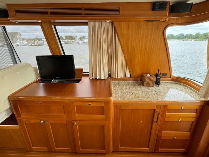 Hezitation Yacht Photos Pics Interior of 2009 Grand Banks 45 Eastbay SX yacht with wooden cabinetry and window view.