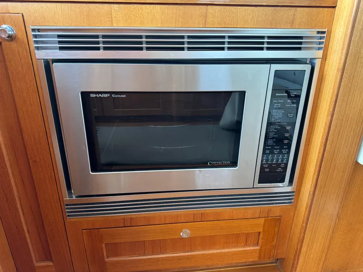 Hezitation Yacht Photos Pics Built-in Sharp microwave in 2009 Grand Banks 45 Eastbay SX yacht kitchen.