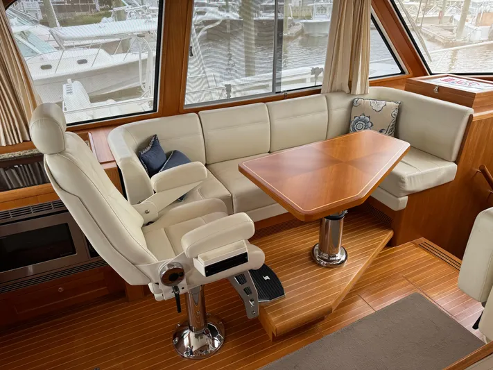Hezitation Yacht Photos Pics Luxurious 2009 Grand Banks 45 Eastbay SX yacht interior with plush seating and wooden table.