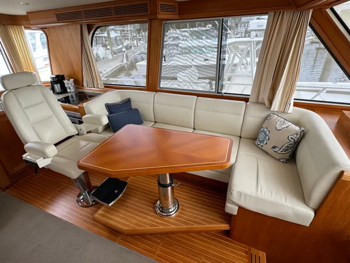 Hezitation Yacht Photos Pics Luxurious interior of 2009 Grand Banks 45 Eastbay SX yacht with leather seating and wooden table.