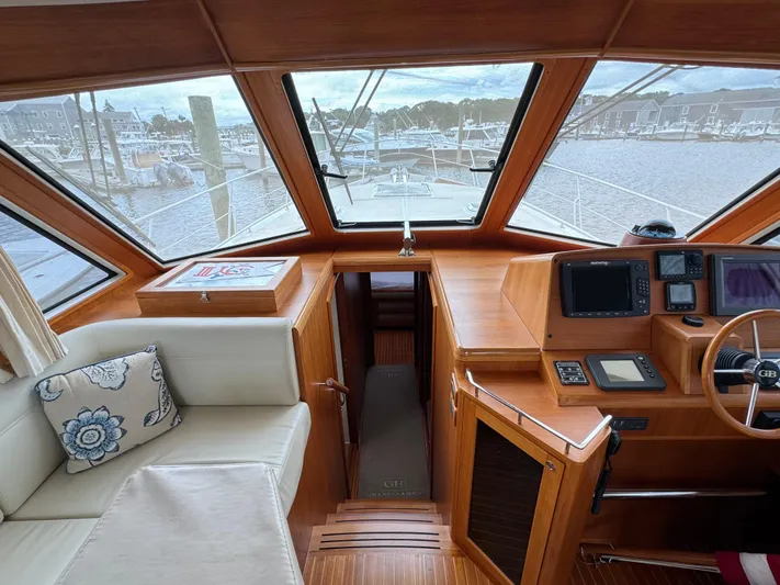 Hezitation Yacht Photos Pics 2009 Grand Banks 45 Eastbay SX helm with panoramic windows and plush seating.