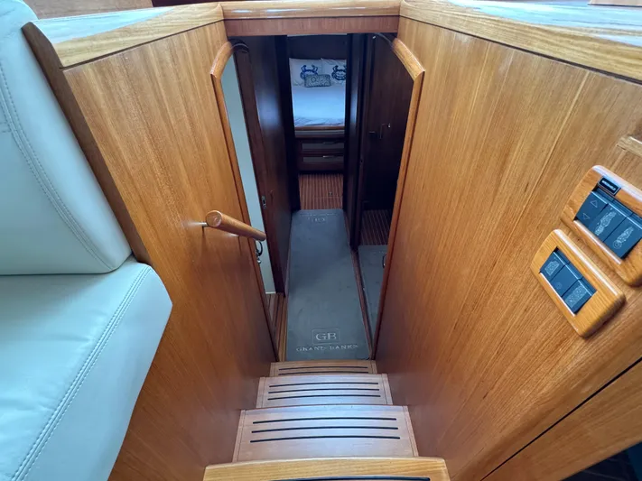 Hezitation Yacht Photos Pics Interior view of 2009 Grand Banks 45 Eastbay SX yacht, featuring wooden stairs and cabin entrance.