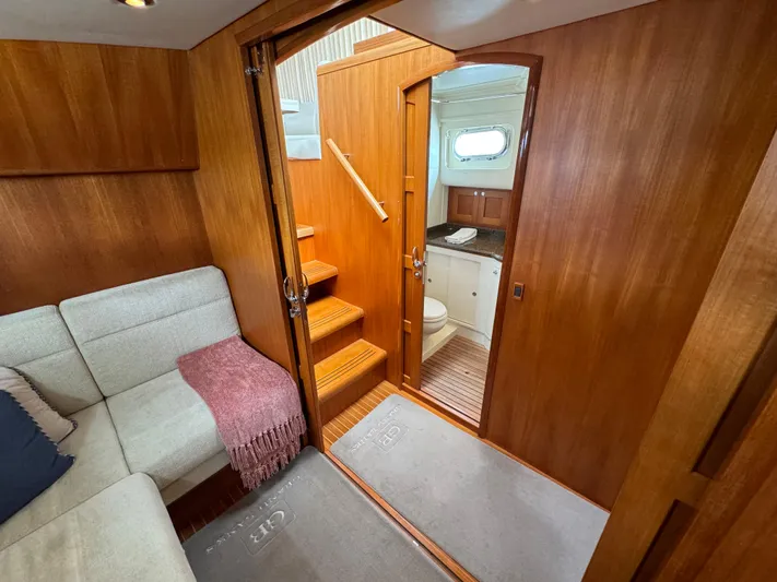 Hezitation Yacht Photos Pics 2009 Grand Banks 45 Eastbay SX interior with wooden finish, cozy seating, and bathroom access.