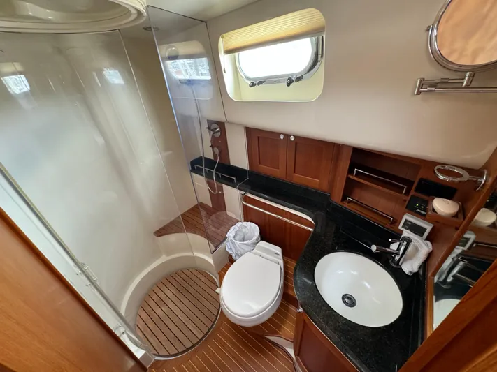 Hezitation Yacht Photos Pics Luxurious 2009 Grand Banks 45 Eastbay SX yacht bathroom with wood accents and modern fixtures.