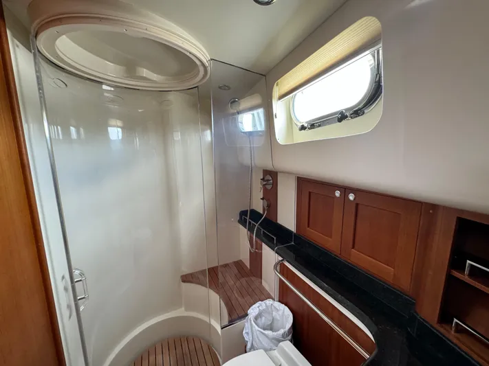 Hezitation Yacht Photos Pics Luxurious bathroom in 2009 Grand Banks 45 Eastbay SX yacht with wooden accents and modern fixtures.