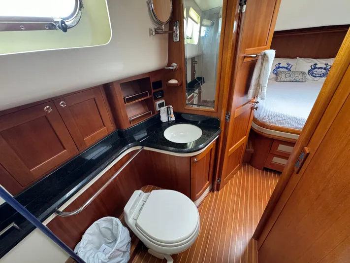 Hezitation Yacht Photos Pics Luxurious 2009 Grand Banks 45 Eastbay SX yacht bathroom with wood accents and modern amenities.